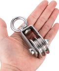 Person holding SHINICO Double Cable Pulley Block Heavy Duty Stainless Steel, Bearing Inside, Swivel Single Pulley Wheel, 550lb load