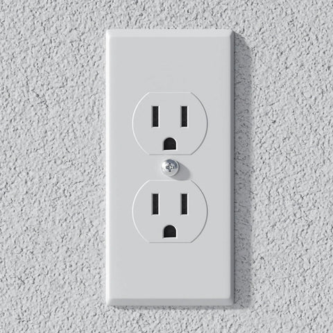 Electrical outlet mounted on textured wall, suitable for various household appliances and electronics.