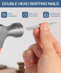 Hand holding a nail from the 400 Pcs Double Head Skirting Nails With Four Tools For Seamless Baseboard Installation In Solid Wood Trim No Pre Drill Needed Angled Driving Barrels Included For Easy Invisible Finish And Double Sided Hidden Fix kit