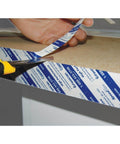 Applying SpeedTape Peel And Stick Double-Sided Adhesive Tape For Edge Banding Made For Woodworking And Diy Home Improvement Ultra Bond Transfer Adhesive Like Contact Cement On A Roll Clear One Inch By Fifty Feet Great For Veneers And Laminates Usa Made on wood surface
