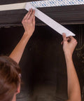 Person applying Double Sided Containment Tape For Painting And Remodeling Sticks To Plastic Sheets Pro Painter Quality on wall