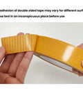 Hands holding Heavy Duty Double Sided Fabric Tape For Carpets And Rugs Crazy Sticky For Home And Office Use Secures Doormats Cushions