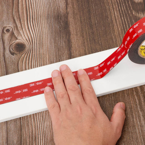 Heavy Duty Double Sided Foam Tape 0.5 Inch By 15.4 Feet 5925 Mega Sticky Mounting Tape being applied to wood surface.
