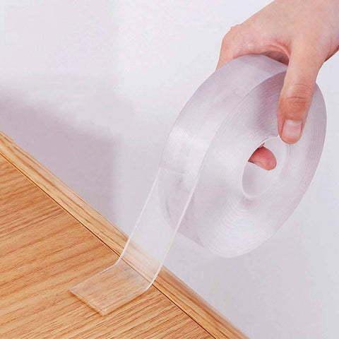 Double Sided Nano Tape 2 Inch By 33 Feet Heavy Duty Mounting Gel Tape Clear Traceless rolled out on wooden surface
