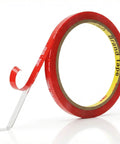 Clear Double Sided Tape One Quarter Inch Ten Feet Heavy Duty Mounting Adhesive with metal hook tool shown next to roll.