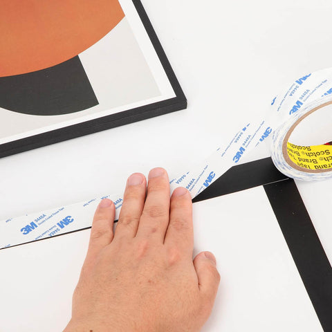 Double Sided Tape 0.5 Inch By 32.8 Feet Thin Translucent Removable Adhesive being used on a picture frame
