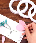 Ultra Thin Double Sided Craft Tape For Card Making Scrapbooking Gift Wrapping And Office And School Use Tear By Hand With Paper Backing Four Rolls One Quarter Inch By Thirty Two Yards Per Roll, shown with crafting materials on a table.
