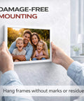 Person mounting a picture frame using Heavy Duty Double Sided Tape For Indoor And Outdoor Use, Ultra Strong Mounting Tape That Sticks To Smooth Surfaces Without Nails, Washable Nano Tape For Picture Frames, Carpets And Decor, 1.18 Inch By 118 Inch, 9.85 Feet.
