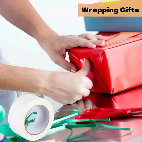 Person using 2 Inch By 40 Yards Double Sided Tape For Crafts And Scrapbooking Clear Strong Adhesive With Easy Tear Paper Backing on gift