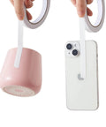Double Sided Adhesive Tape One Quarter Inch Wide Four Rolls holding pink cup and smartphone, demonstrating strength and versatility.