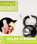 Heavy Duty Clear Double Sided Tape Removable Nano Mounting Adhesive Tape For Walls Photos Crafts Posters And Carpets 1 Inch By Sixteen Point Five Feet Waterproof With Strong Load Bearing For Damage Free Hanging holding a 6 lb kettlebell and being applied by hand.