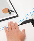 Double Sided Tape 0.39 Inch By 16.5 Feet Heavy Duty PE Foam Mounting Tape Removable Waterproof applied to a frame.