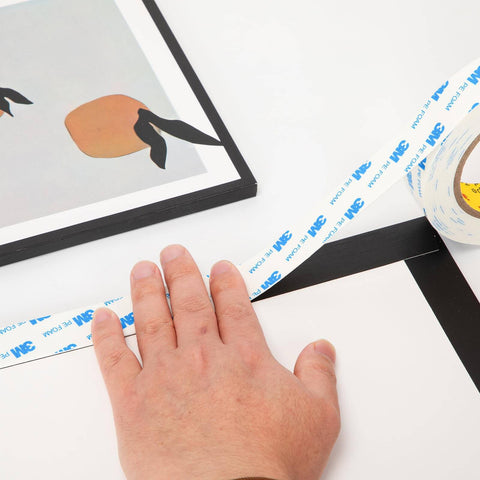Double Sided Tape 0.39 Inch By 16.5 Feet Heavy Duty PE Foam Mounting Tape Removable Waterproof applied to a frame.