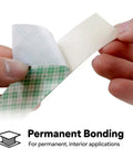 Close-up of hands peeling Double Sided Urethane Foam Tape With Super Sticky Acrylic Adhesive For Bonding Attaching And Mounting White 1 Inch By 5 Yard Roll Gap Filling On Textured Or Uneven Surfaces.