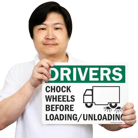 Person holding Chock Wheels Before Loading And Unloading Sign For Drivers, 10 By 14 Inch Aluminum, Heavy Duty Rustproof Outdoor Safety Sign With Four Corner