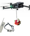 Drone Airdrop System With Release Device And Payload Clip For Safe And Precise Airdrops Of Fish Bait Or Small Supplies, Compatible With DJI Mini Series Air Series Mavic 3, Mavic 2, Spark, Easy Velcro Belly Mount, Essential Drone Accessory attached to a drone with a floral payload.