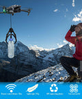 Universally Drone Airdrop System With Mechanical Claw Payload Release attached to a DJI drone carrying a plastic bottle over a snowy mountain.