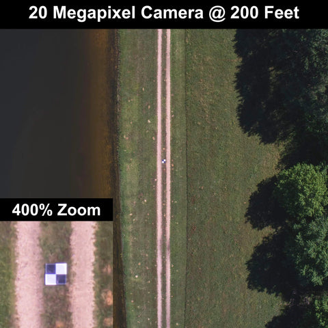 Aerial view of a Bulls Eye 24x24 Drone Ground Control Point Targets Six Pack For Mapping And Surveying in a field with black and white markers.