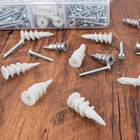 Self Drilling Drywall Anchors Assortment Kit with scattered #6 zinc and #8 plastic anchors on wooden surface