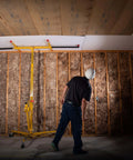 Worker using ✝️ Drywall Lift, The Original, Professional-Grade Sheetrock Hoist 138-2, 150 lbs, Rolling Panel Lift for ceiling installation