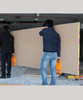Two men using ✝️ 2 Pcs Carrier Drywall Tools ABS Plastic Panel Carrier Drywall Lift for Plywood Sheetrock Panels in construction site.