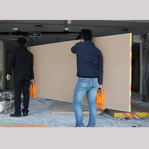 Two men using ✝️ 2 Pcs Carrier Drywall Tools ABS Plastic Panel Carrier Drywall Lift for Plywood Sheetrock Panels in construction site.