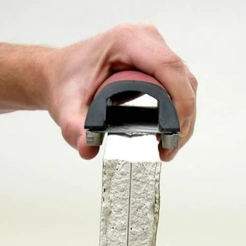 Efficient 5.5 inch drywall rasp with guard rails shaping plaster edge, DuraSoft grip for dual-direction use, precise finish.