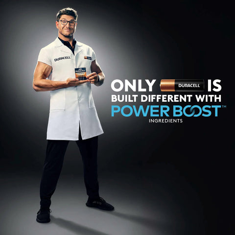 Man holding Coppertop AAA Alkaline Batteries With Power Boost For Long Lasting Home Use with Power Boost text in background