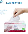 Hand pulling a Powder Free Vinyl Glove 4.3 Mil Clear Latex Free For Food Service Cleaning from a box, showing easy storage features.