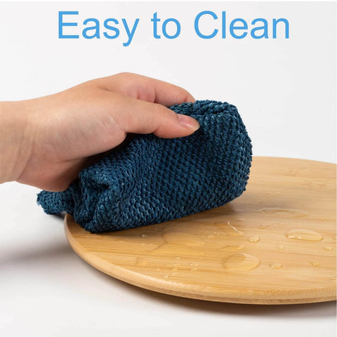 Hand wiping a 10 inch bamboo wood lazy susan organizer designed for cabinets and countertops.