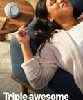 Woman relaxing on sofa with Echo Dot Max Graphite Finish on table, delivering room-filling sound and built-in smart home hub.