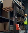 Powerful Fully Electric Pallet Stacker That Handles Up To 3300 Lbs Like A Boss, Lifts Up To 98.4 Inches, Straddle Legs And Forks For Easy Pallet Handling, Adjustable Fork Width From 8.66 To 31.1 Inches, 2.2KW Motor, Orange And Black By VEVOR in a warehouse lifting a large pallet.