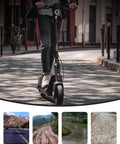 Person riding a scooter with 9.5 x 2.50 Off-Road Tire in urban setting, showcasing its use on various terrains like roads and trails.