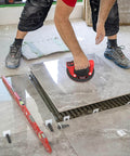 Worker using 8 Inch Electric Glass Vacuum Suction Cup Lifter Beefy 600 Lbs Max Load on tile installation