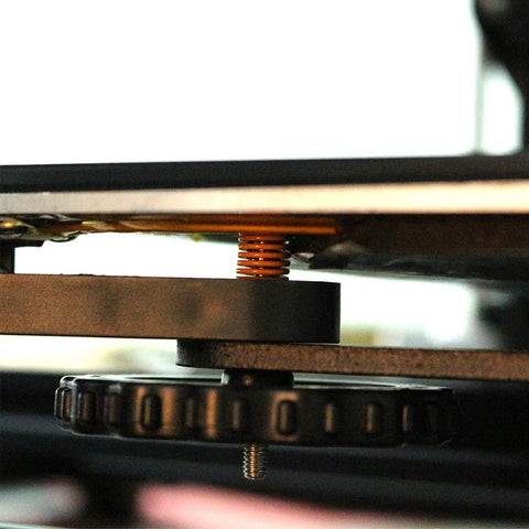 Close-up of yellow compression spring installed in Ender 3 bed assembly, showcasing light load 8mm OD 20mm long die spring pack of 20