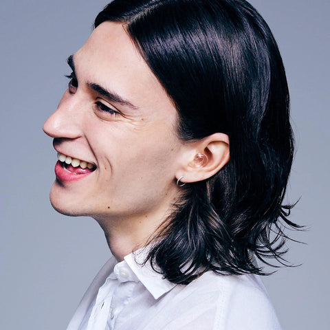 Person smiling wearing Engage 2 Ear Plugs For Everyday Use With 16 dB Noise Reduction And Clear Speech, side view