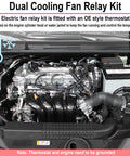Car engine with dual cooling fan relay kit, OE style thermostat, visible wiring connections, and battery shown inside engine bay.