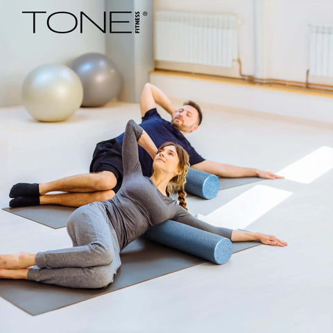 Two people using High Density EPP Foam Exercise Roller For Yoga Pilates Stretching Massage And Recovery 36 Inch Black for myofascial release.