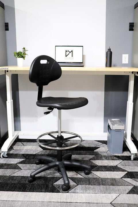 Boss Bench Height Ergonomic Chair Stool with easy-to-clean polyurethane seat in office setting, adjustable from 18 to 26 inches, 450 lb capacity.