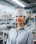 Woman wearing Anti Static Cleanroom Hat Breathable Working Cap in electronics manufacturing environment.