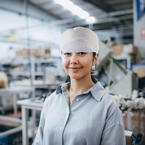 Woman wearing Anti Static Cleanroom Hat Breathable Working Cap in electronics manufacturing environment.