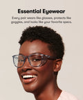 Person wearing Z87.1 Certified Safety Glasses With Blue Light Blocking And Anti Fog Coating, smiling in a casual setting.