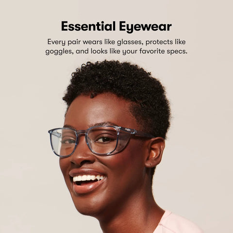 Person wearing Z87.1 Certified Safety Glasses With Blue Light Blocking And Anti Fog Coating, smiling in a casual setting.