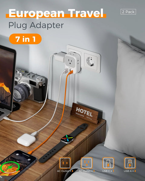 European Plug Adapter USB C 2 Pack with 4 Outlets and 3 USB Chargers in use on a bedside table charging multiple devices in a hotel room.