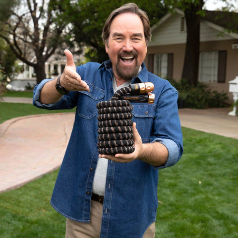 Person holding Expandable Garden Hose Copper Bullet With Ten Pattern Thumb Spray Nozzle As Seen On TV 650 PSI Lead Free.