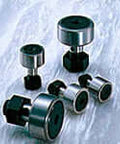CF10-1WBR CF Series flanged cylindrical single unit, sealed ball design for linear slide units, in an array on a textured surface.