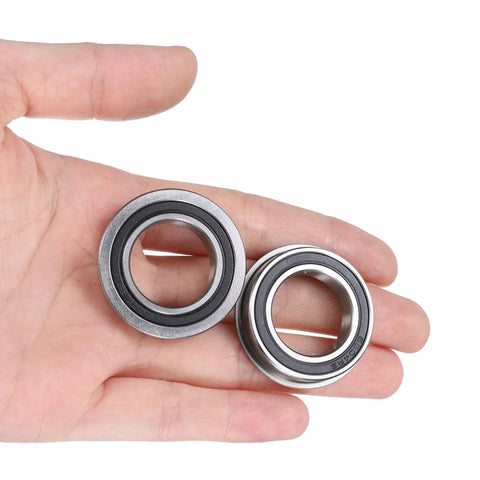 Person holding two Flanged Ball Bearing F6804-2RS 20x32x7mm, double sealed chrome steel bearings with GCr15 races and rubber seals.