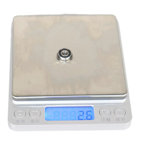 F695-2RS Flanged Ball Bearing ABEC-9 on digital scale showing weight, 5x13x4mm, chrome steel, for high speed motors and 3D printers