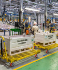 Factory workers using platform trucks with 5"x2" Industrial Casters- Heavy Duty casters, Polyurethane Casters Wheel for smooth motion.