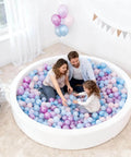 Family playing in a ball pit filled with pastel Ball Pit Balls - 100pcs - Crush Proof Plastic Children's Toy Balls Macaron Ocean Balls for Birthday Christmas Parties Games Pool